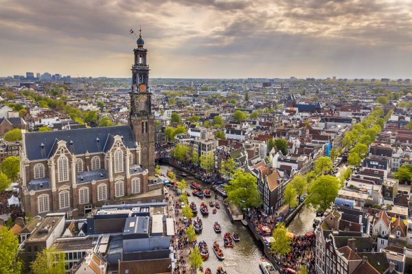 Amsterdam aerial view of Westerkerk church seen from north on Koningsdag Kings day festivities. Birthday of the king. Seen from helicopter.